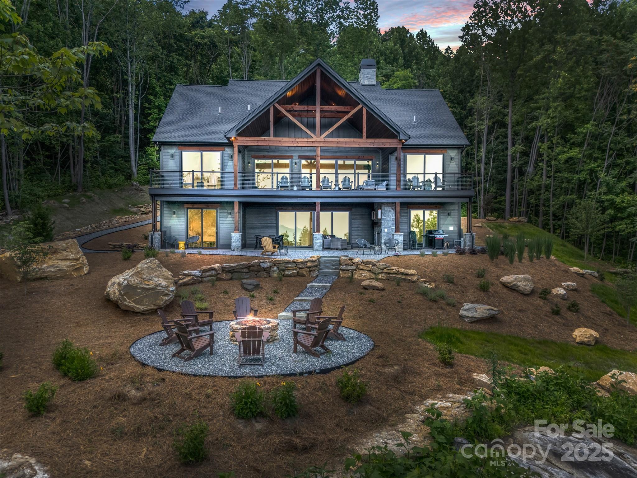 627 Cherry Hill, Unit 201 Mill Spring, NC 28756 - Photo 36 of 48 a front view of a house with a yard and lake view