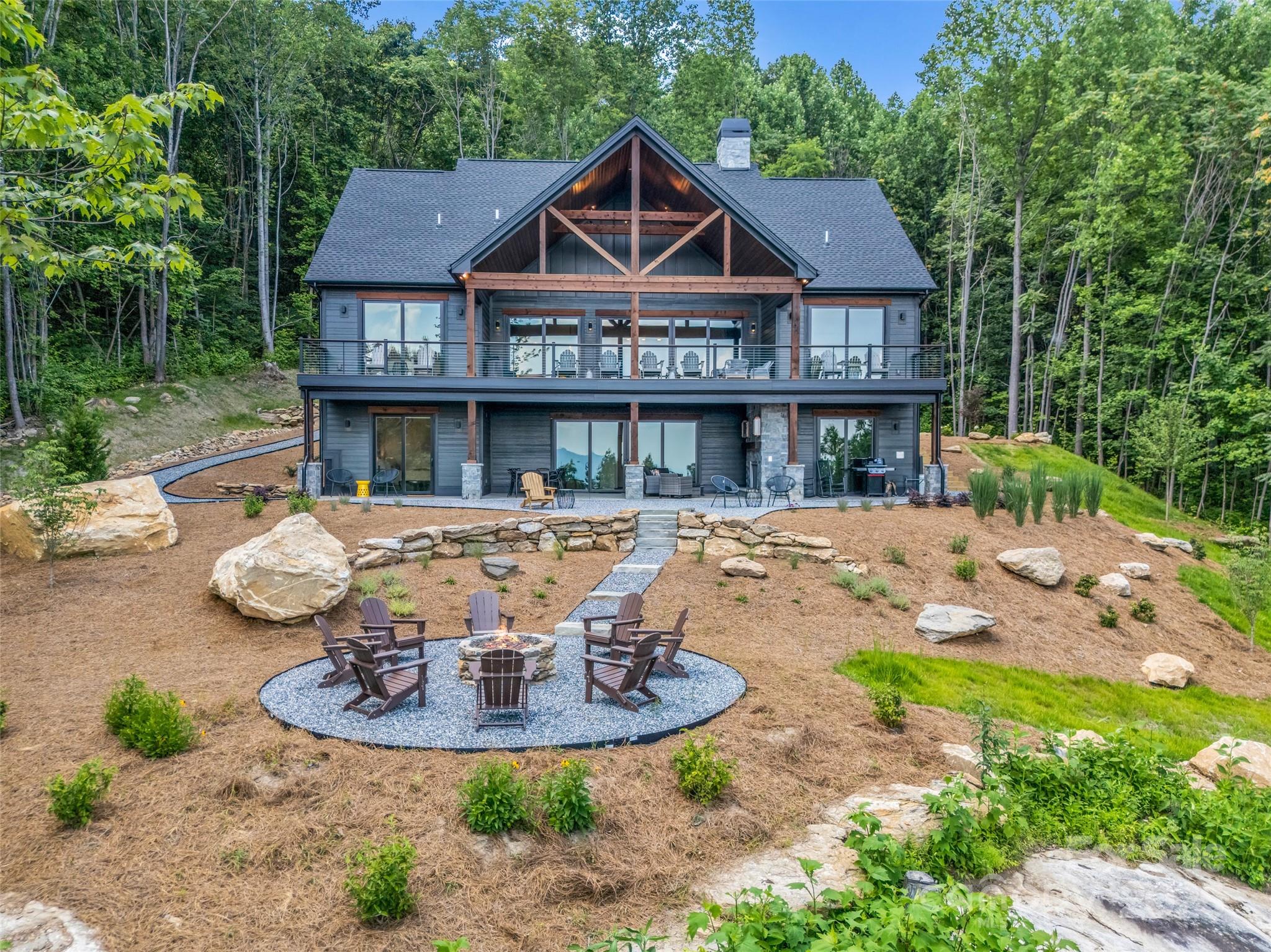 627 Cherry Hill, Unit 201 Mill Spring, NC 28756 - Photo 38 of 48 a front view of a house with a yard table and chairs