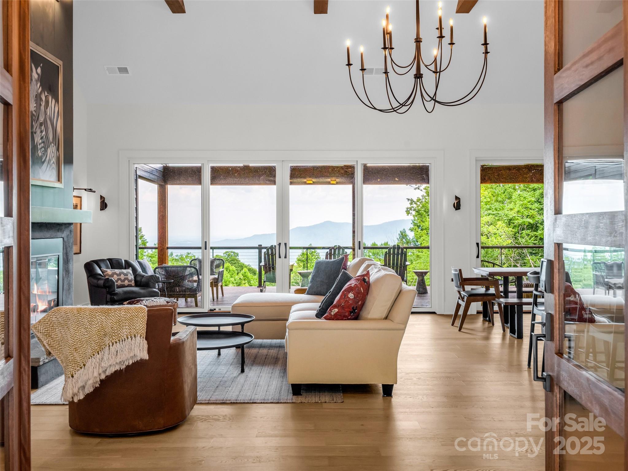 627 Cherry Hill, Unit 201 Mill Spring, NC 28756 - Photo 5 of 48 a living room with fireplace furniture and a large window