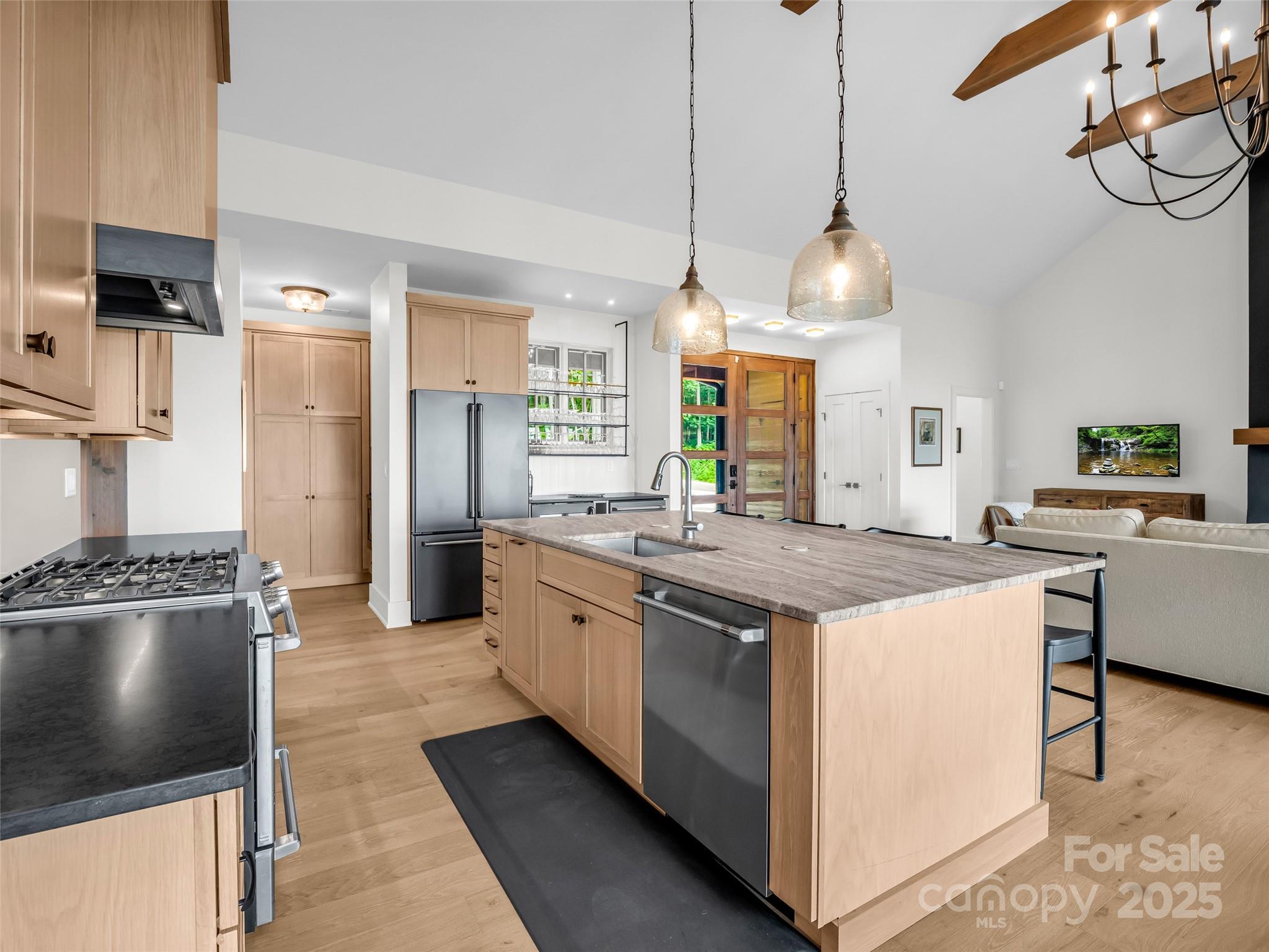 627 Cherry Hill, Unit 201 Mill Spring, NC 28756 - Photo 9 of 48 a kitchen with stainless steel appliances granite countertop a stove and a center island