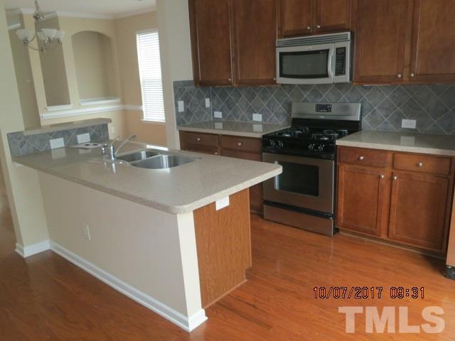2969 Casona Way Raleigh, NC 27616 - Photo 7 of 7 a kitchen with stainless steel appliances granite countertop a stove a sink and a microwave