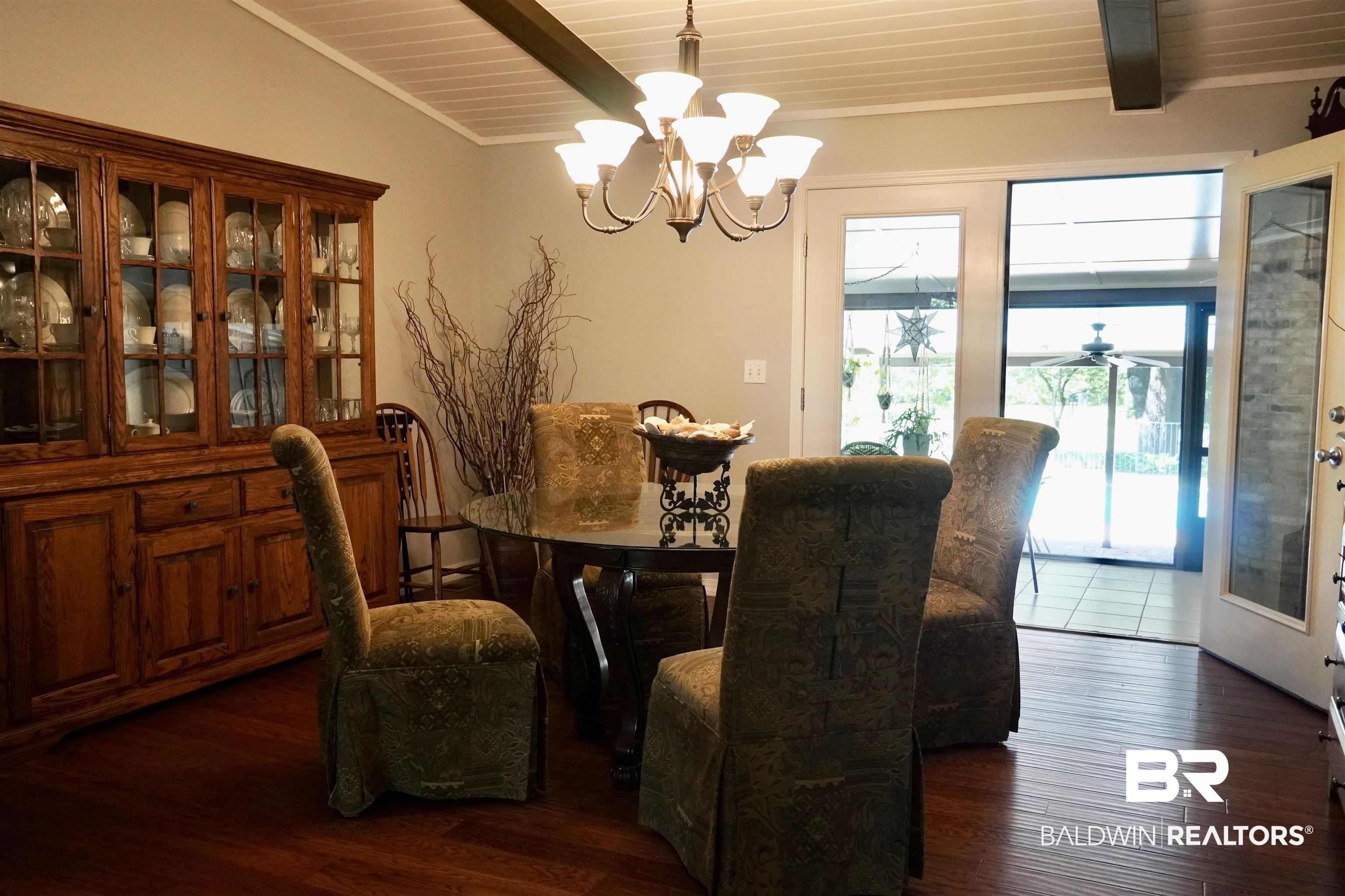 117 Belle Meade Brewton, AL 36426 - Photo 13 of 62 Dining space featuring wood ceiling, lofted ceiling with beams, dark wood-type flooring, and a chandelier