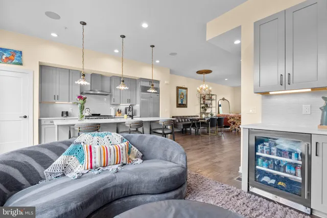 a living room with furniture and kitchen view
