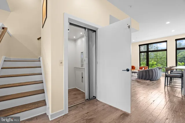 a view of a livingroom with wooden floor and furniture