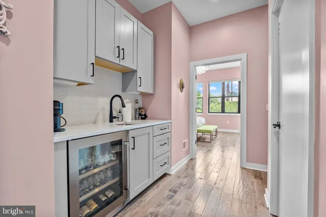 a kitchen with a sink cabinets and wooden floor