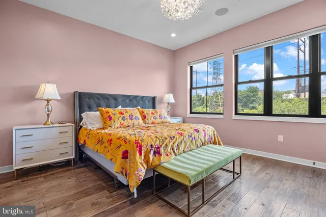 a bed sitting in a bedroom next to a window