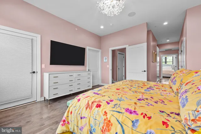 a bedroom with a bed and a flat screen tv in it