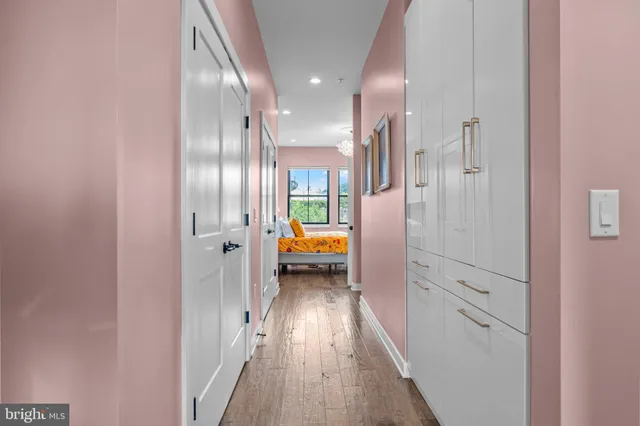 a view of hallway with wooden floor