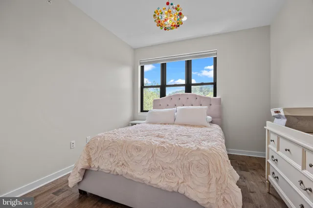 a large bed sitting in a bedroom next to a window