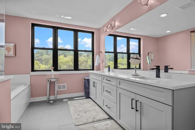 a large kitchen with kitchen island granite countertop a large window