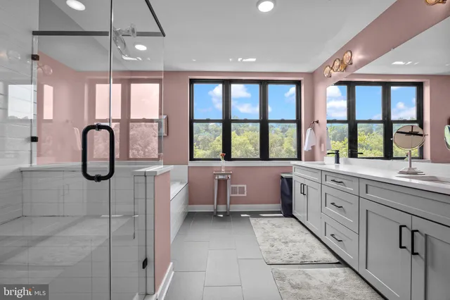 a large kitchen with kitchen island granite countertop a large window and a sink