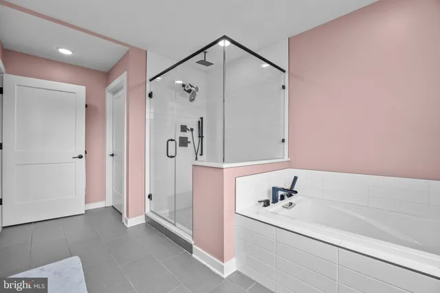 a bathroom with a bathtub and a shower