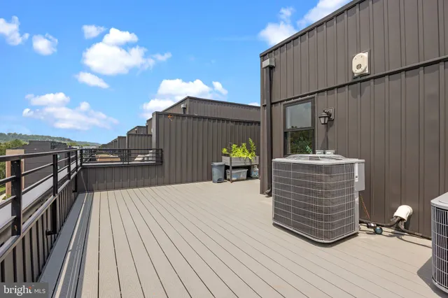 a living room with patio furniture and a potted plant