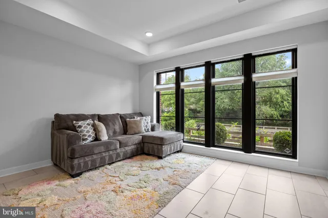 a living room with a large window and a glass door