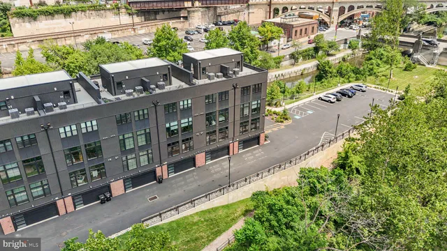 a aerial view of a house with a yard and lake view in back