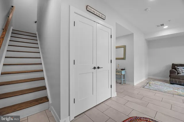 a view of a hallway with closet and workspace