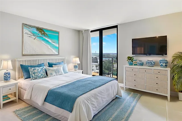 a spacious bedroom with a bed and glass walk in closet