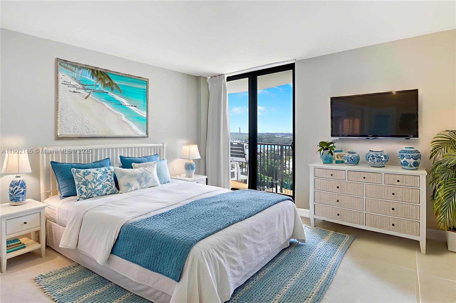 200 South Beach Road, Unit 703 Tequesta, FL 33469 - Photo 17 of 52 a bedroom with a large bed and a flat screen tv