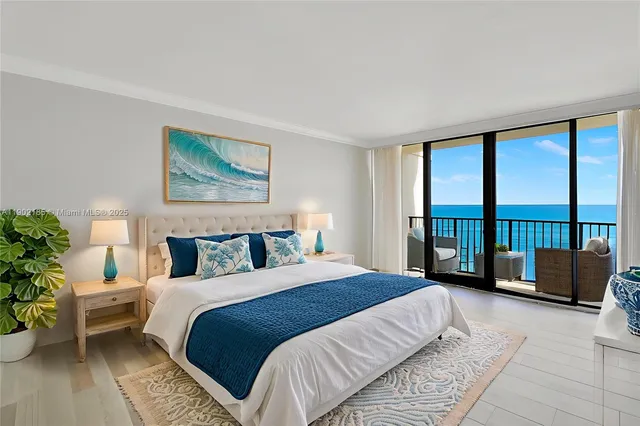 a bedroom with furniture and a large window