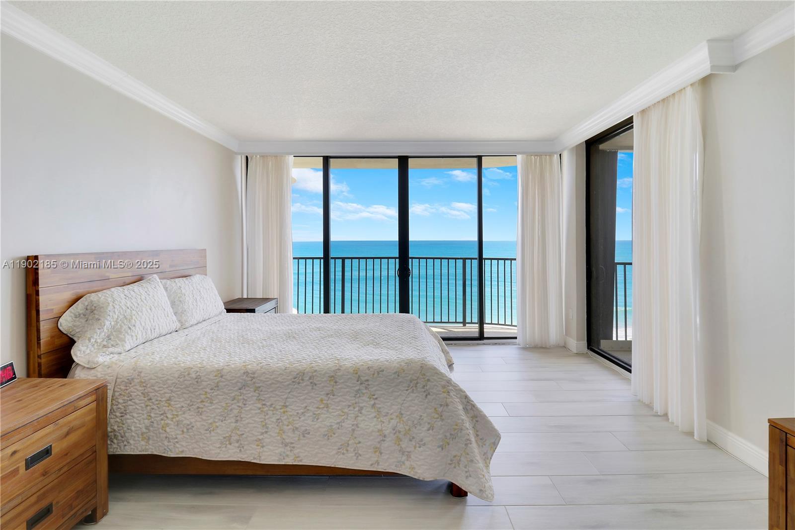 200 South Beach Road, Unit 703 Tequesta, FL 33469 - Photo 24 of 52 a bedroom with a large bed and a large window
