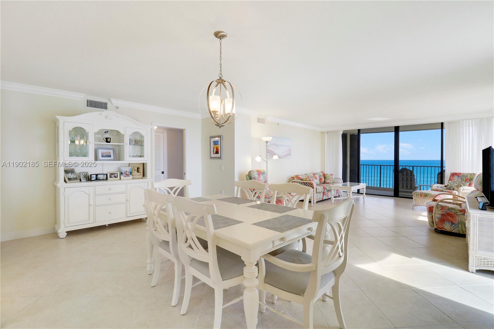 200 South Beach Road, Unit 703 Tequesta, FL 33469 - Photo 34 of 52 a view of a dining room with furniture and chandelier