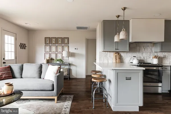 a living room with furniture and kitchen view