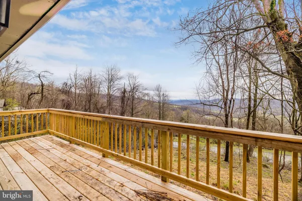 a view of balcony with wooden floor and fence