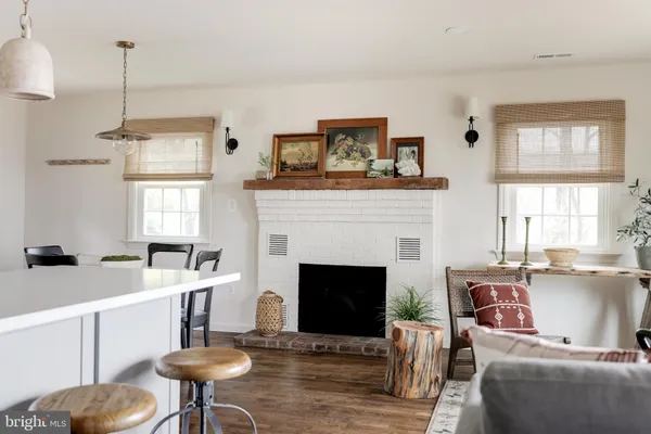 a living room with furniture a window and a fireplace