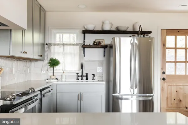 a kitchen with a refrigerator and a sink