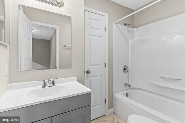 a bathroom with a bathtub shower sink and a toilet
