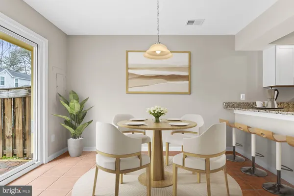 a view of a dining room with furniture wooden floor and a chandelier