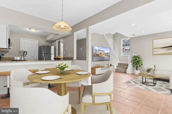 a dining room with furniture and a chandelier