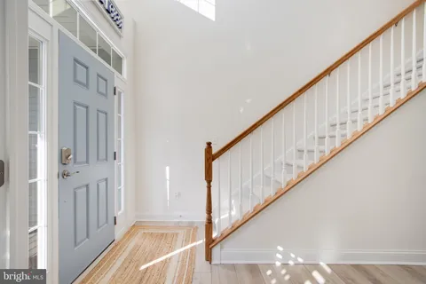 a kitchen with a dining table chairs stainless steel appliances and cabinets