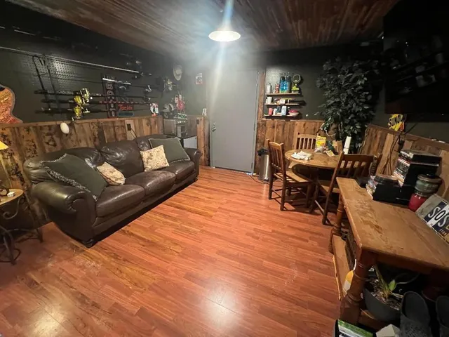 a dining room with furniture and wooden floor