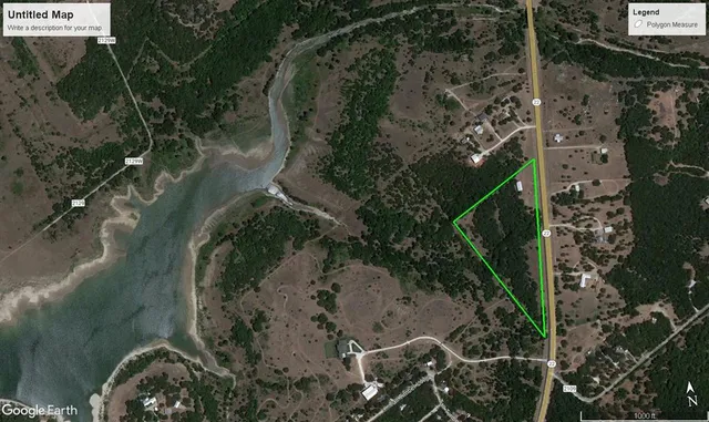 a view of dirt yard with large trees