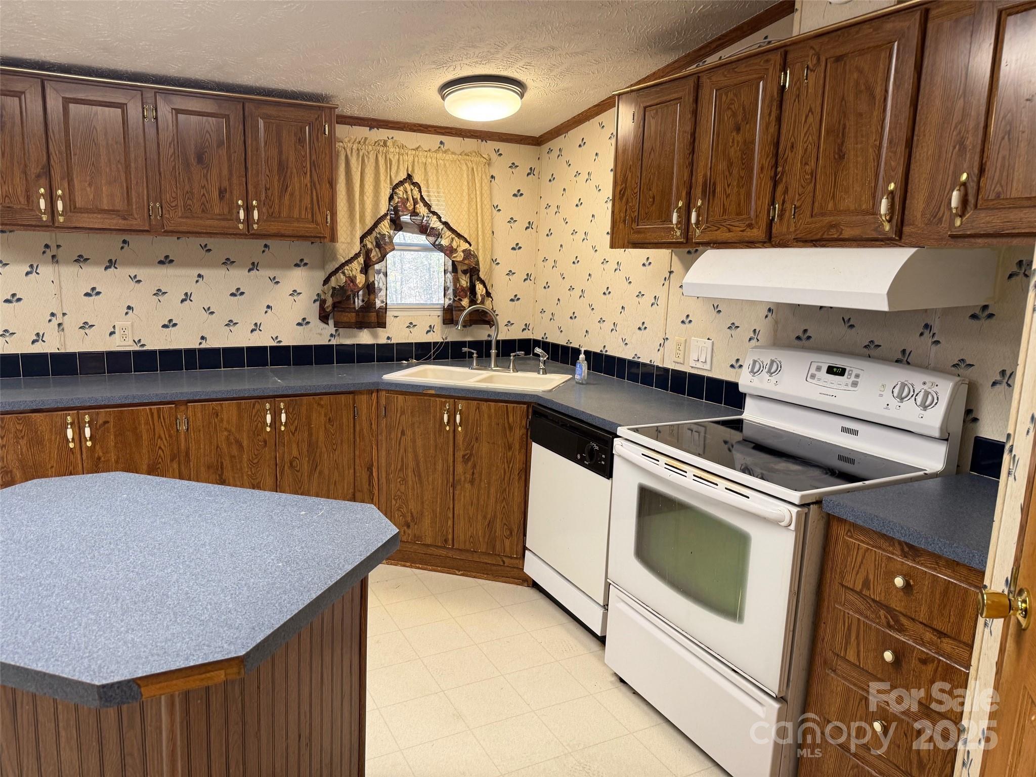 7159 Rev Melvin Adams Road Kershaw, SC 29067 - Photo 12 of 28 a kitchen with stainless steel appliances granite countertop a sink a stove and cabinets