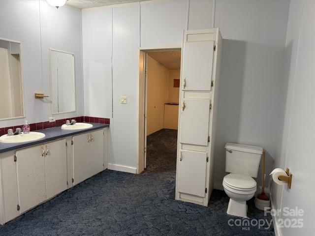 7159 Rev Melvin Adams Road Kershaw, SC 29067 - Photo 20 of 28 a bathroom with a granite countertop toilet a sink and a mirror
