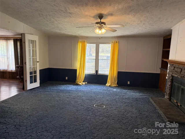 a view of livingroom with window and fireplace