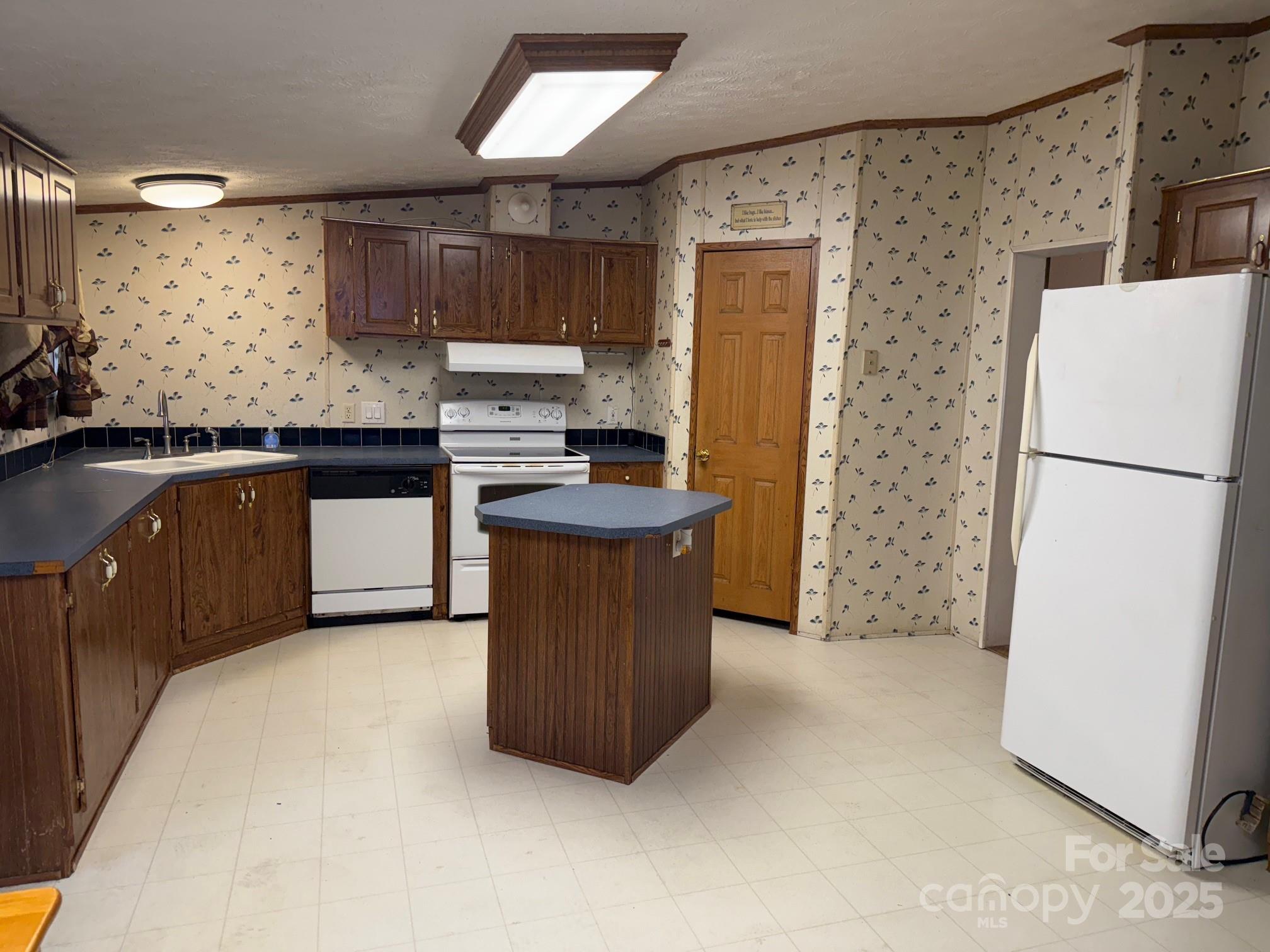7159 Rev Melvin Adams Road Kershaw, SC 29067 - Photo 10 of 28 a kitchen with stainless steel appliances granite countertop a refrigerator a stove a sink and a microwave