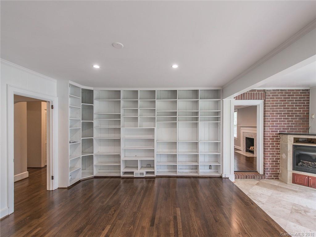 2711 Providence Road Charlotte, NC 28211 - Photo 18 of 35 an empty room with wooden floor and fireplace