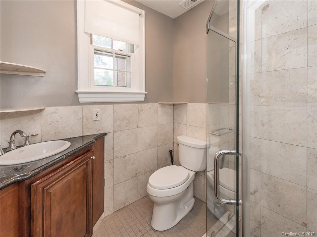 2711 Providence Road Charlotte, NC 28211 - Photo 21 of 35 a bathroom with a toilet sink and mirror