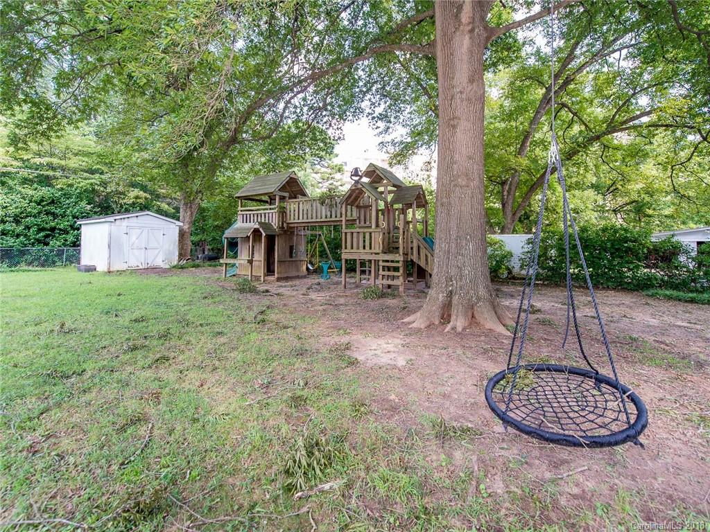 2711 Providence Road Charlotte, NC 28211 - Photo 32 of 35 a view of a backyard with table and chairs potted plants and large tree