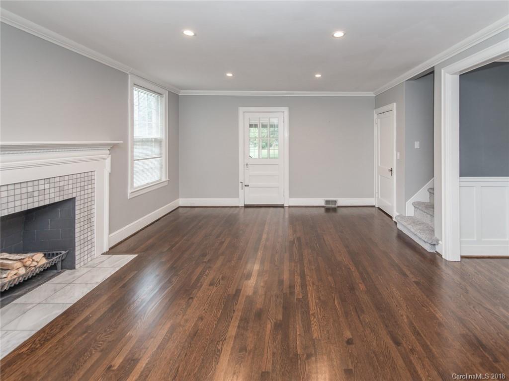 2711 Providence Road Charlotte, NC 28211 - Photo 7 of 35 a view of empty room with wooden floor and fireplace
