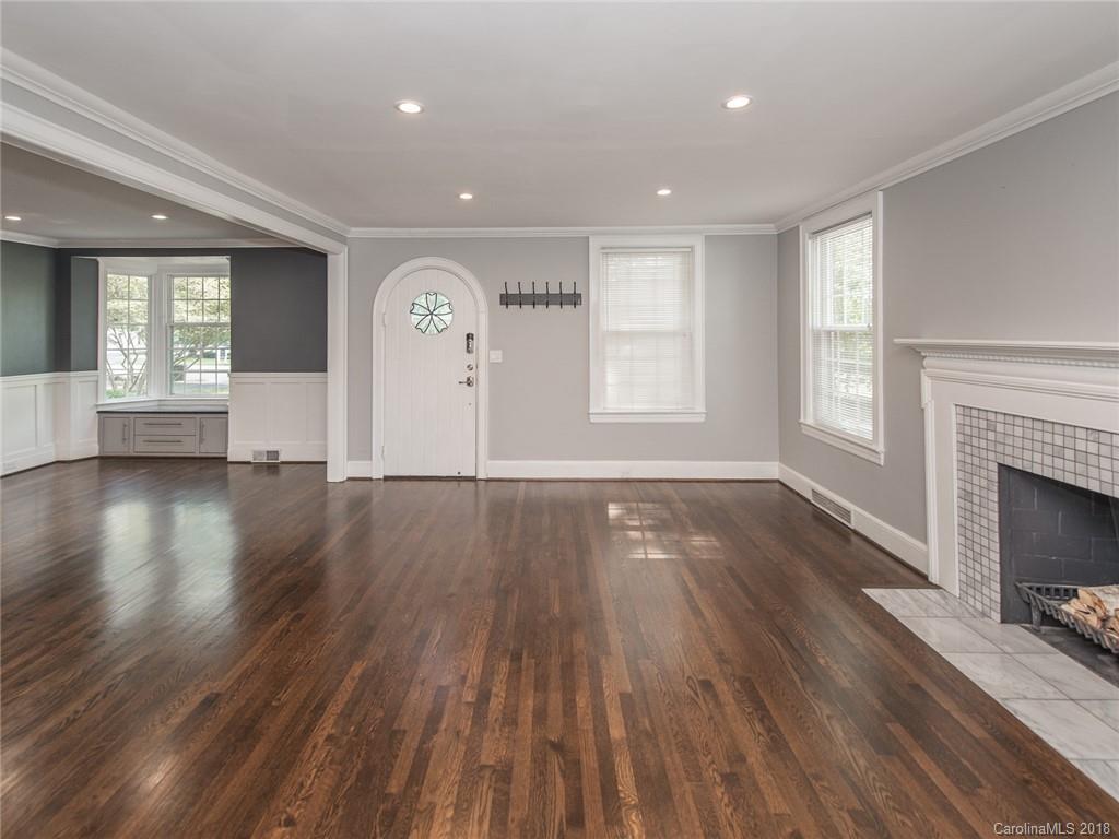 2711 Providence Road Charlotte, NC 28211 - Photo 8 of 35 an empty room with wooden floor fireplace and windows