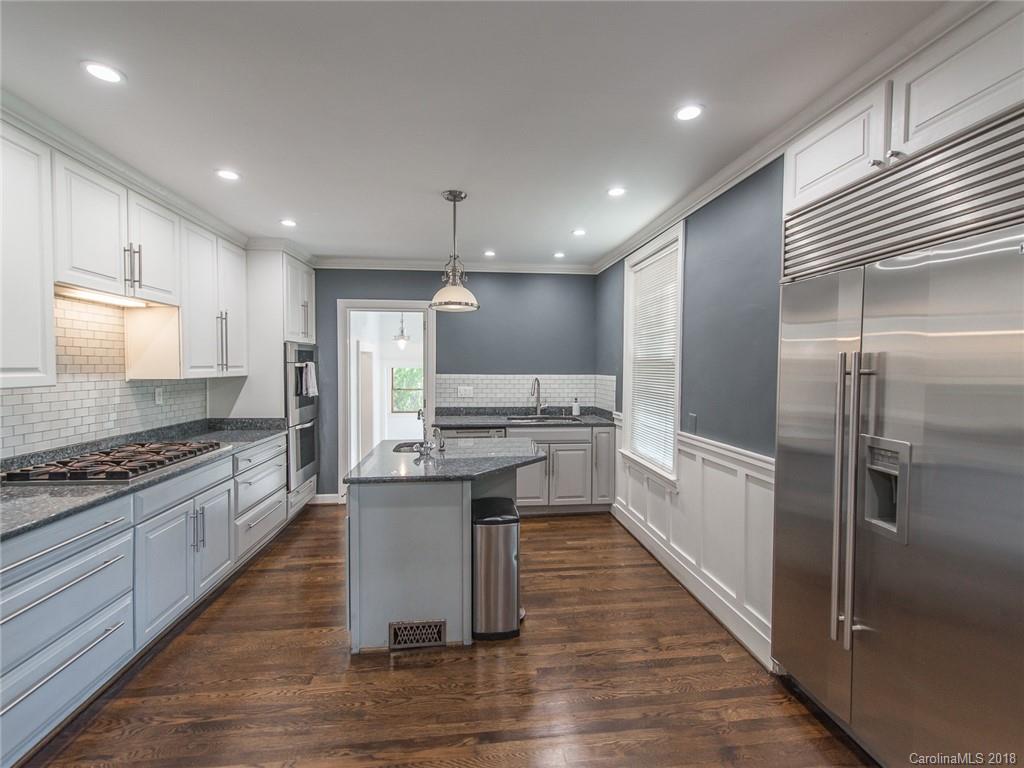 2711 Providence Road Charlotte, NC 28211 - Photo 9 of 35 a large kitchen with a center island wooden floor stainless steel appliances and cabinets