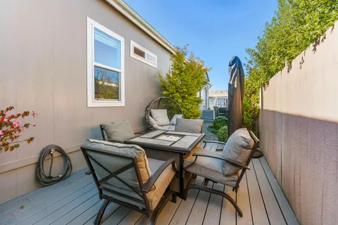 a backyard of a house with table and chairs