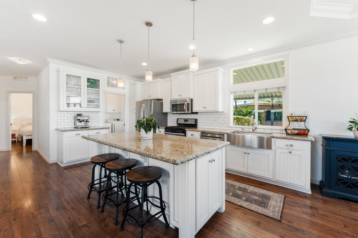 3950 Via Real, Unit 97 Carpinteria, CA 93013 - Photo 21 of 38 a kitchen with stainless steel appliances granite countertop sink stove and wooden floor
