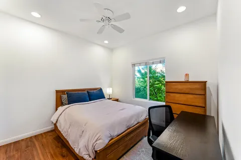 a bedroom with a bed a table and chair