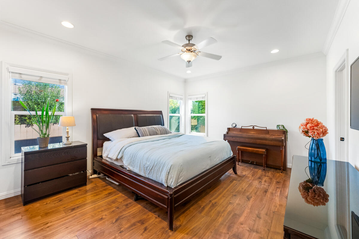 3950 Via Real, Unit 97 Carpinteria, CA 93013 - Photo 27 of 38 a bedroom with a bed and dresser with wooden floor