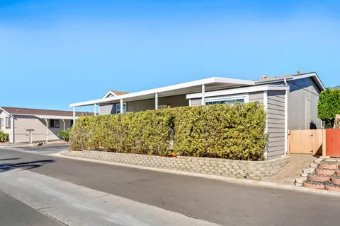 a store with outdoor seating area and car parked